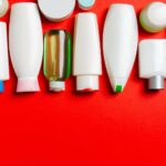 Slika pokazuje uticaj kozmetike na životnu sredinu ilustrativno kroz prikaz praznih boca na crvenoj pozadini.